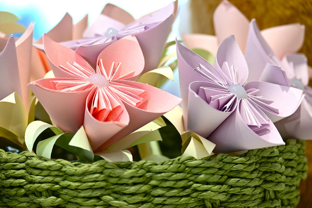 Pink and lilac paper flowers. Origami art concept